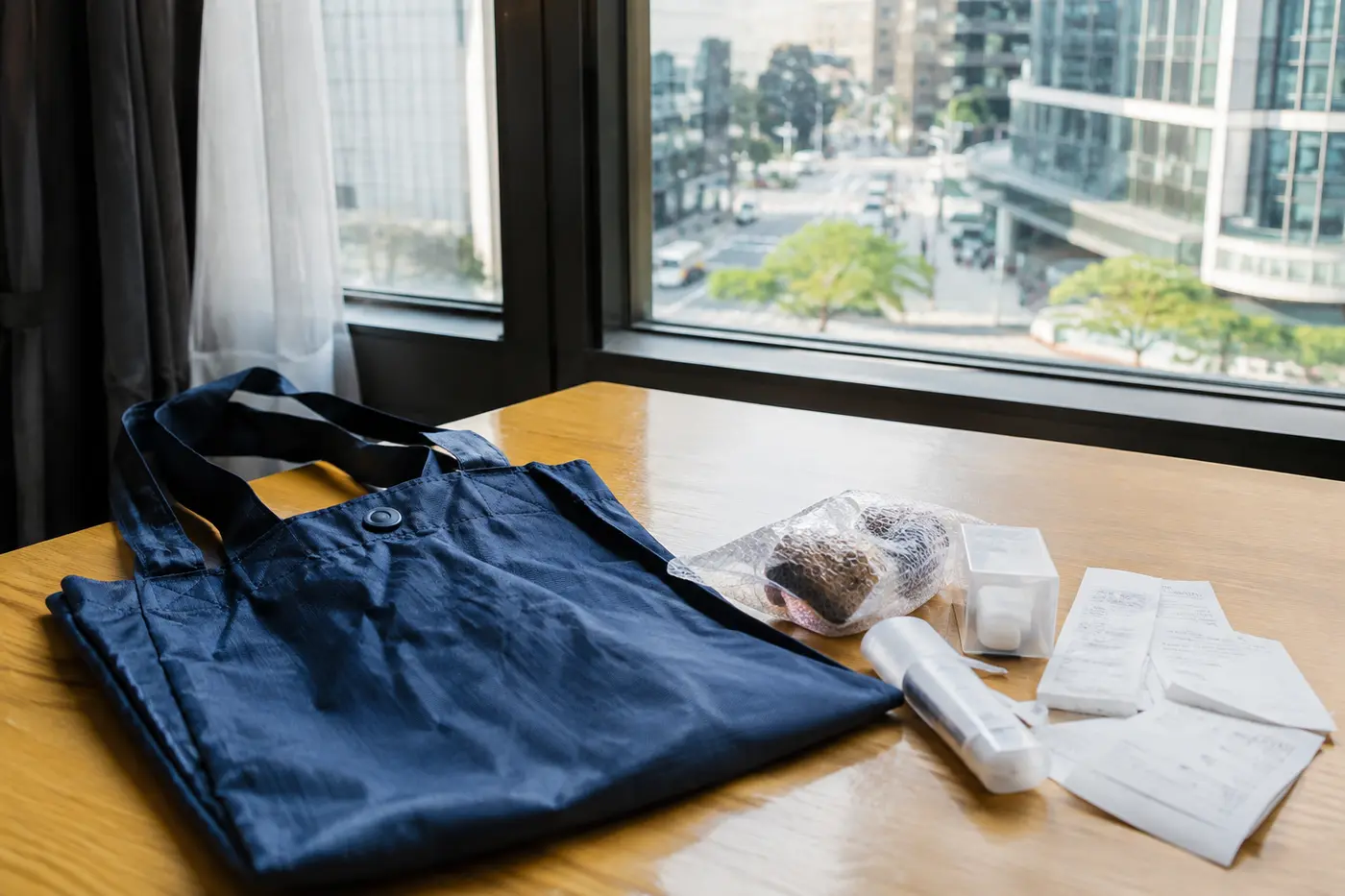 A compact budget-shopping kit with foldable bag, receipts and small purchases