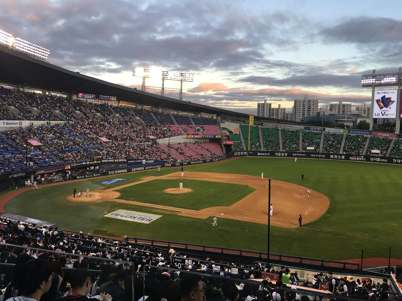A Korean baseball cheering section singing behind the dugout