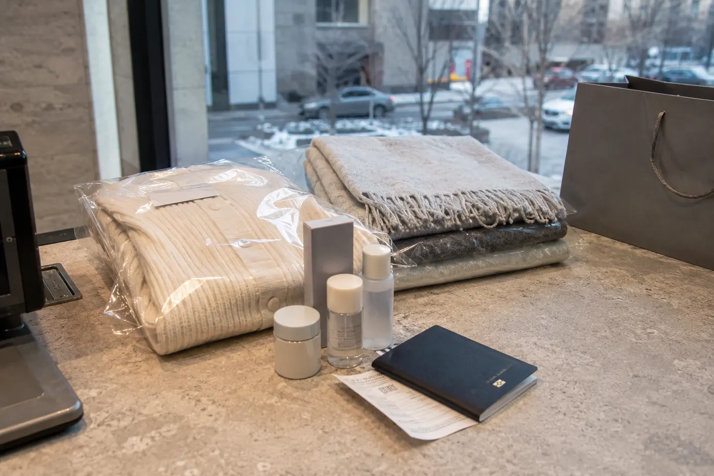 Eligible packaged clothing, cosmetics and accessories beside a passport and receipt