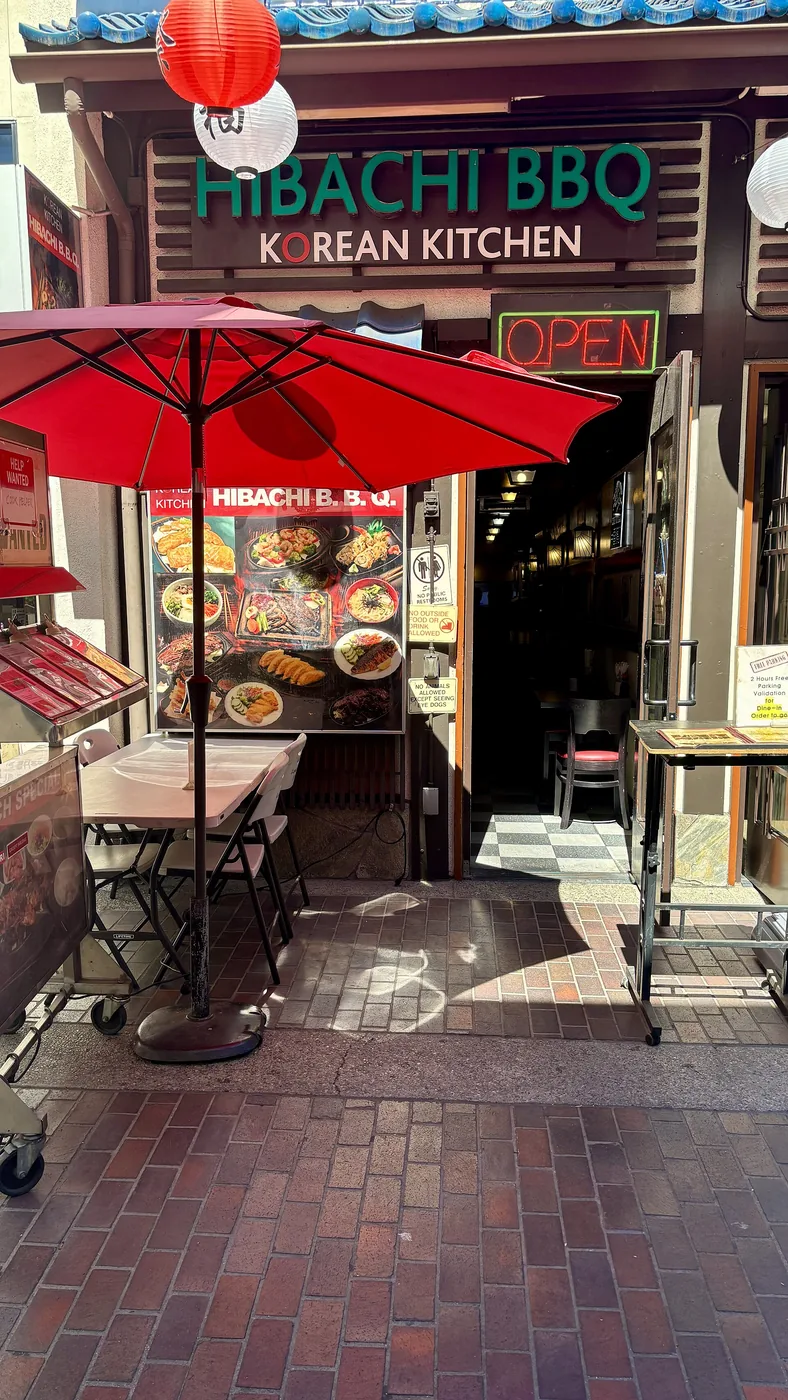 A Korean barbecue restaurant with tabletop grills and exhaust hoods