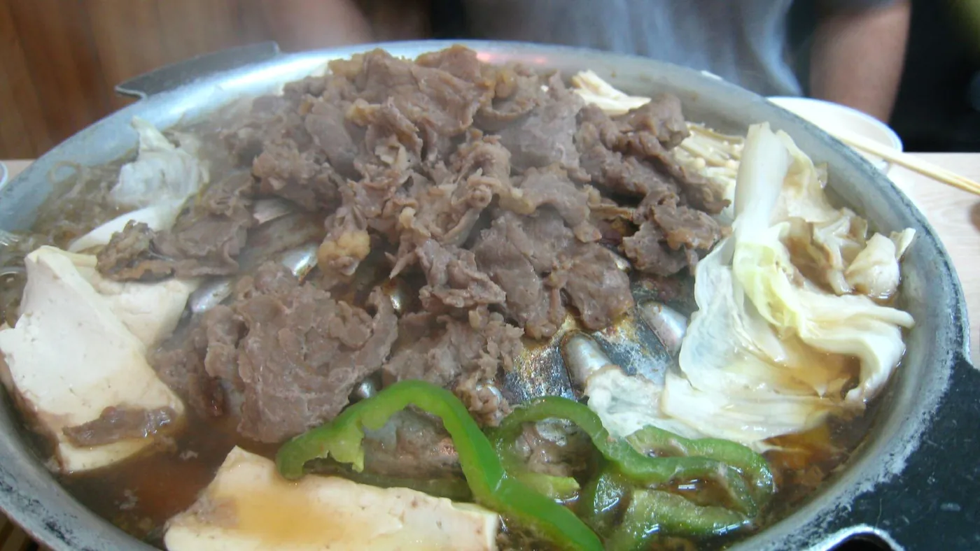 Bulgogi served with rice and Korean side dishes