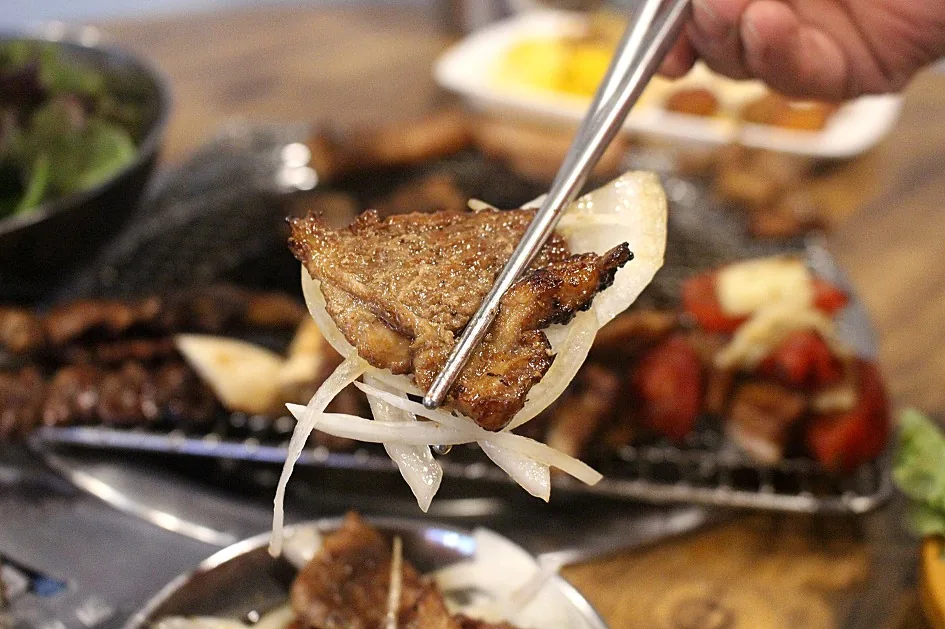 Korean galbi ribs grilling over a tabletop flame