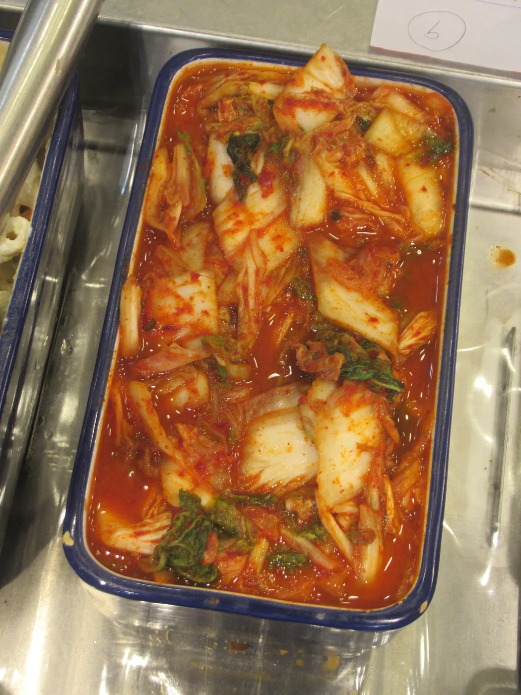 Napa cabbage kimchi on a white plate