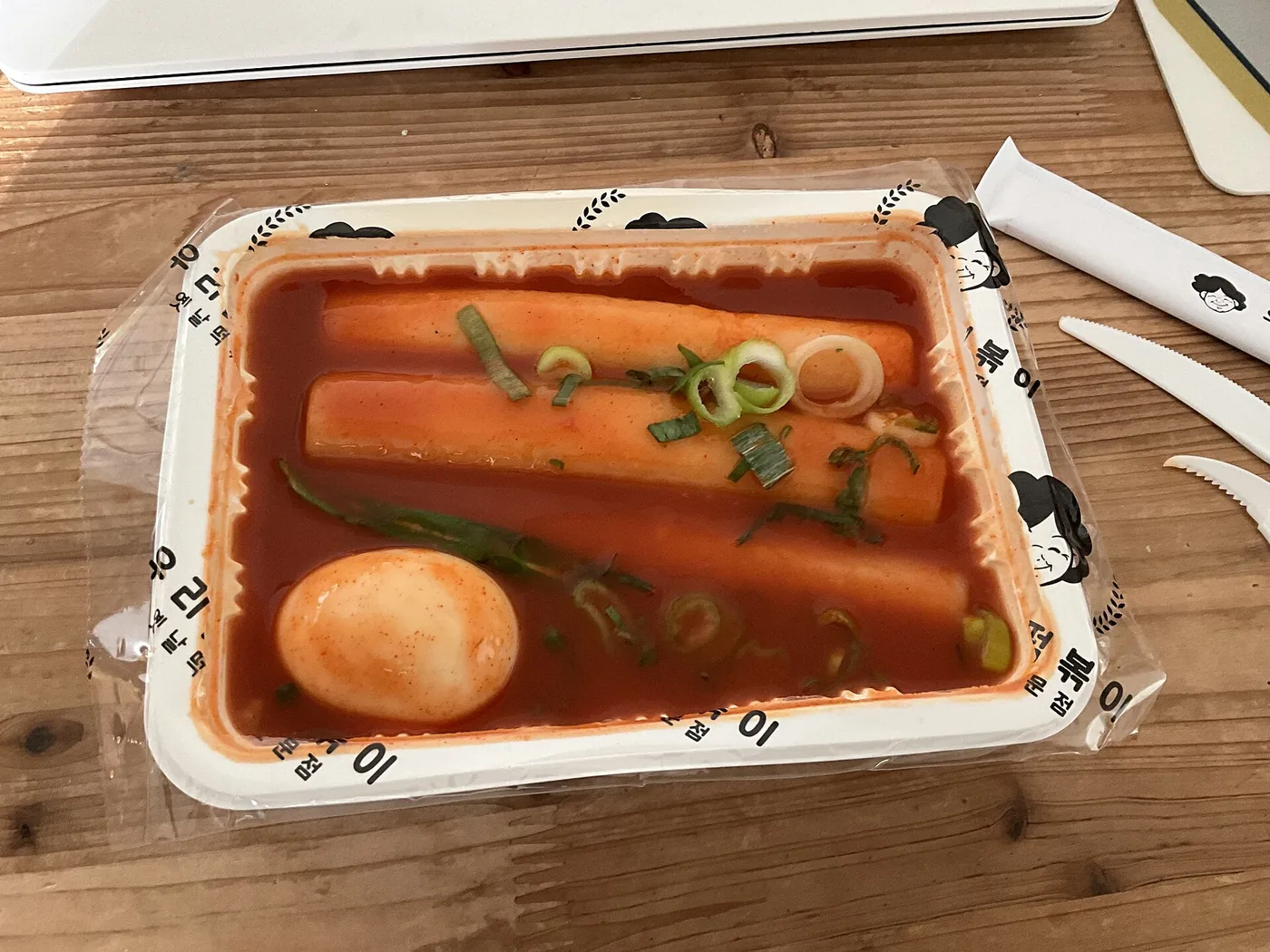 Tteokbokki rice cakes simmering in a red gochujang sauce