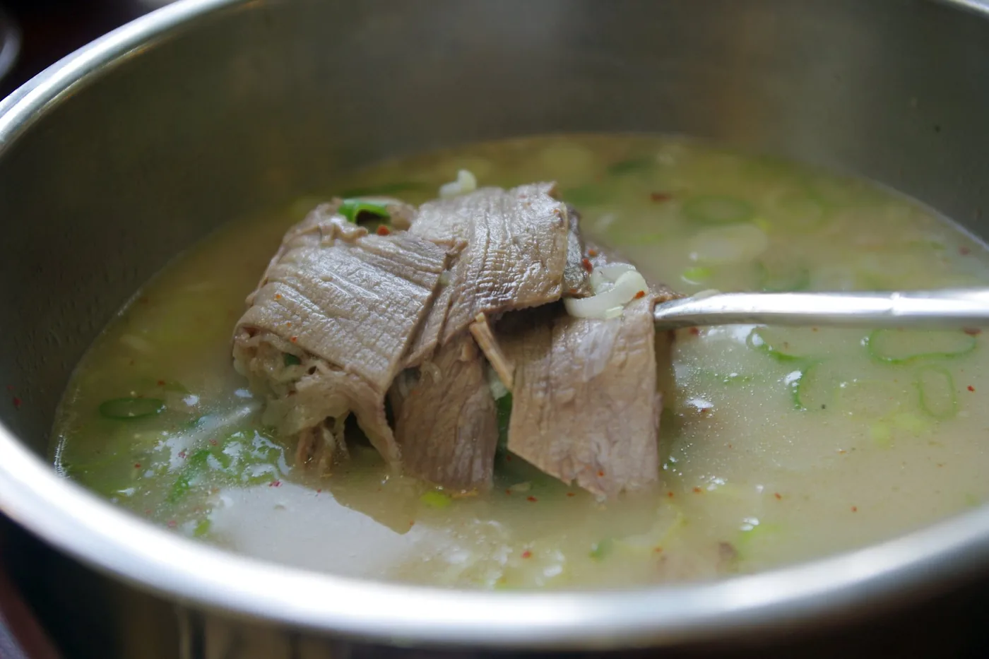 Milky seolleongtang ox-bone soup with beef and green onion