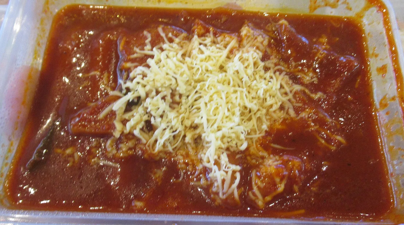 Tteokbokki rice cakes simmering in a red gochujang sauce