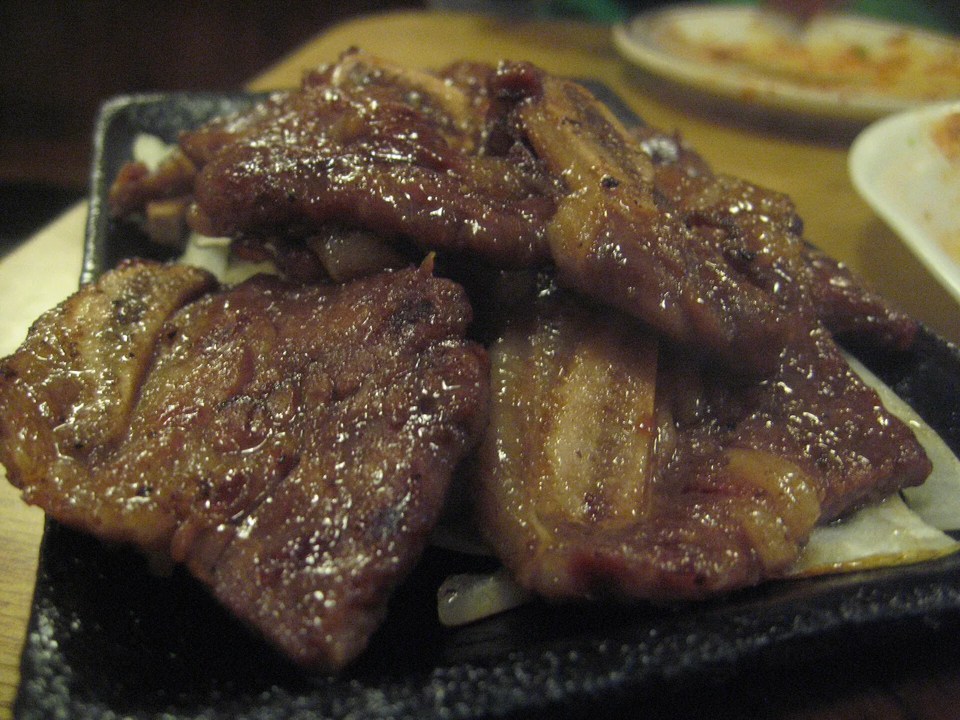 Korean galbi ribs grilling over a tabletop flame