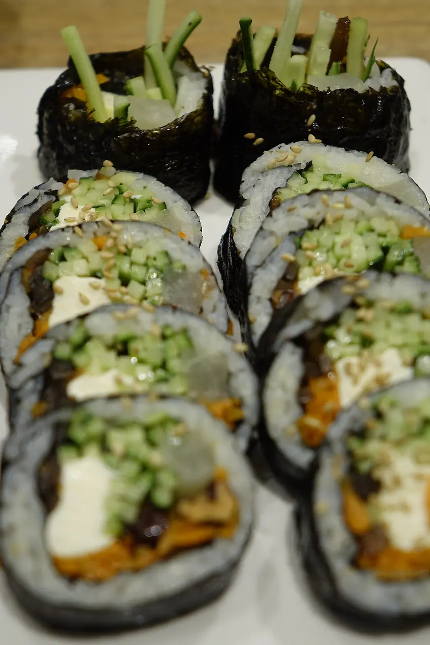 Sliced gimbap showing rice, vegetables and fillings wrapped in seaweed