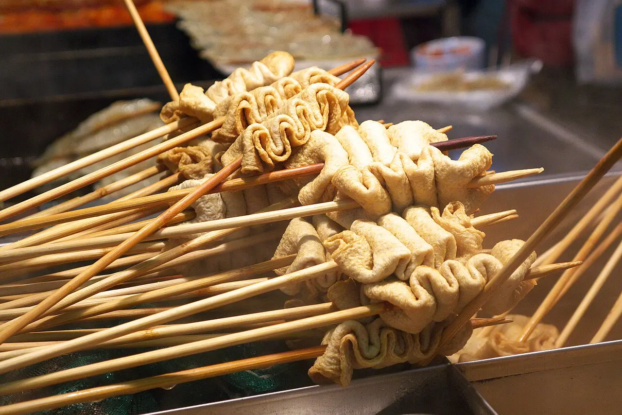 Folded eomuk fish cakes served on skewers at a street stall