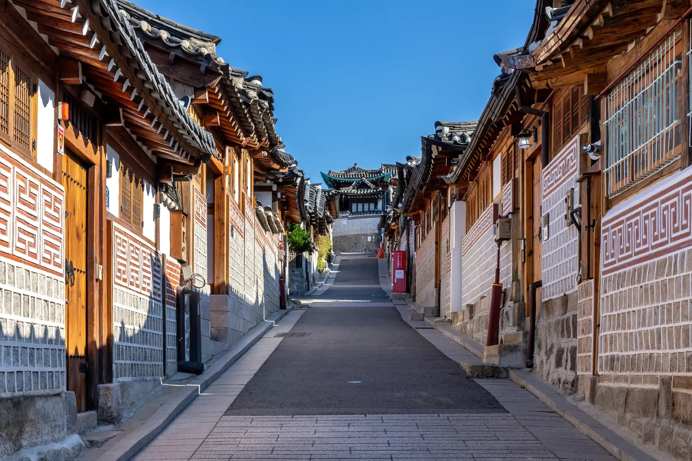A real view along Bukchon-ro 11-gil with traditional hanok houses and blue sky