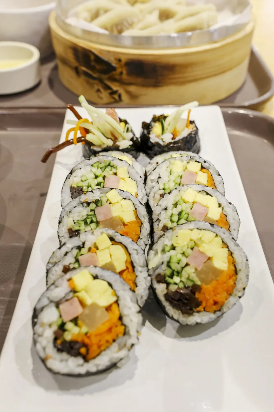 Sliced gimbap showing rice, vegetables and fillings wrapped in seaweed