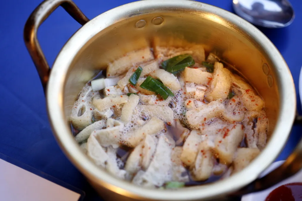 Folded eomuk fish cakes served on skewers at a street stall