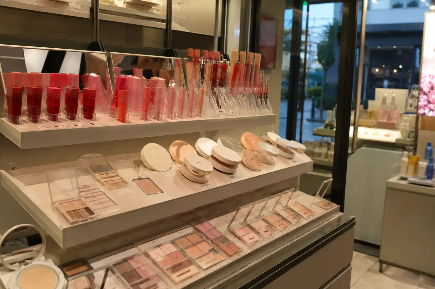 Lip tints, cushion compacts and small makeup palettes displayed with testers