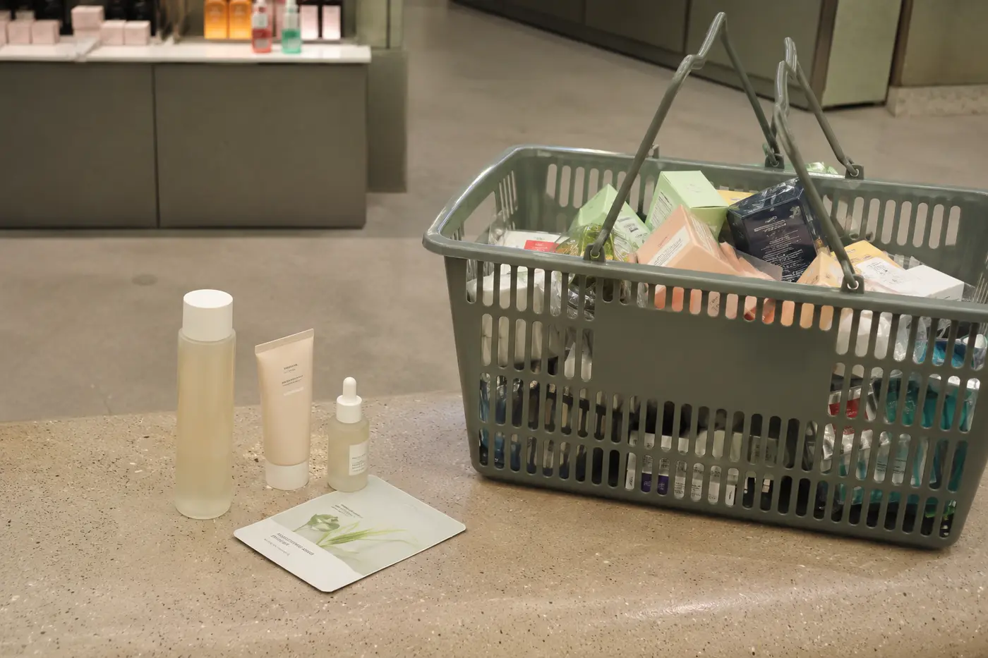 A carefully edited small beauty haul beside a much larger rejected basket