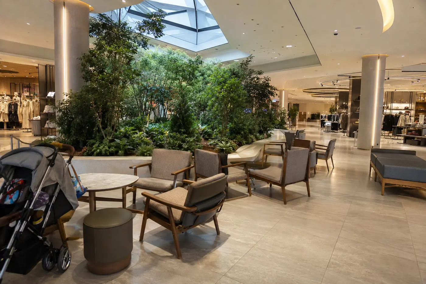 A bright department store rest area with family seating and indoor greenery