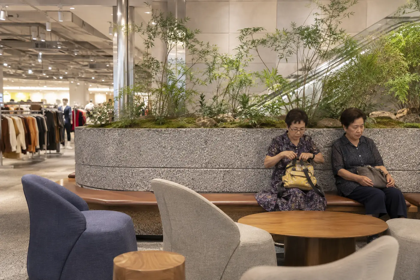 A calm family resting area away from a crowded shopping queue