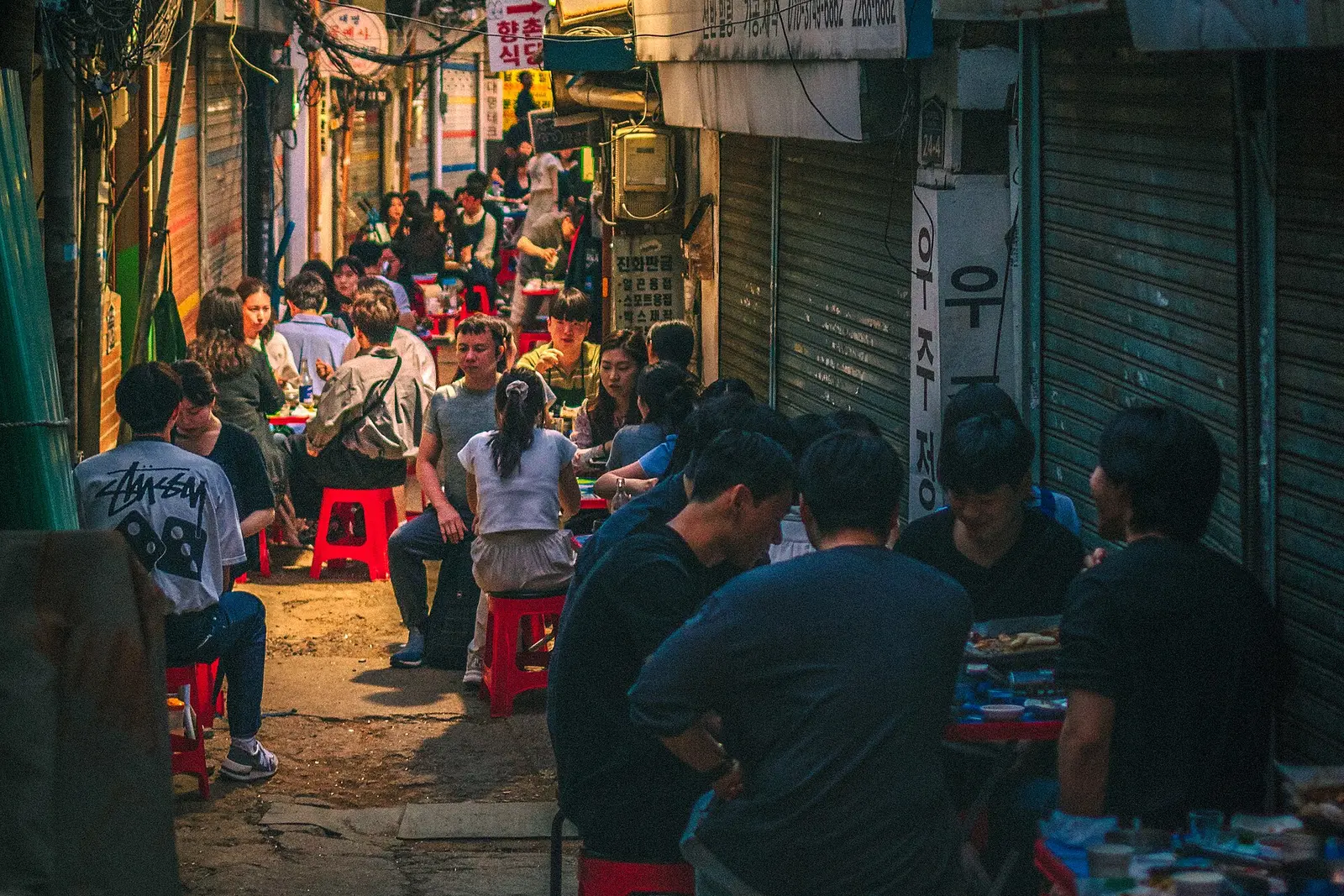 Outdoor tables filling an Euljiro alley at night