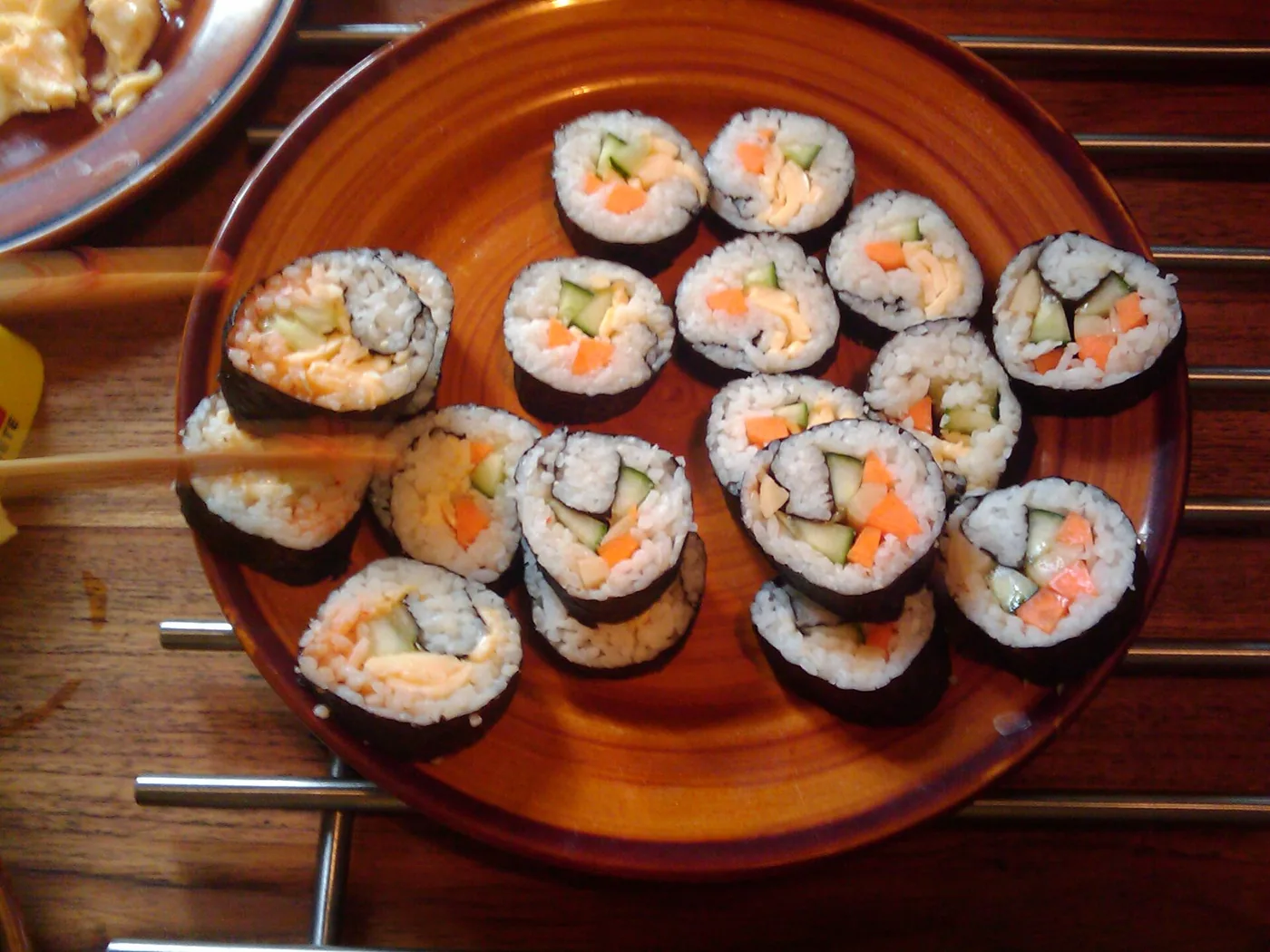 Sliced gimbap showing rice, vegetables and fillings wrapped in seaweed