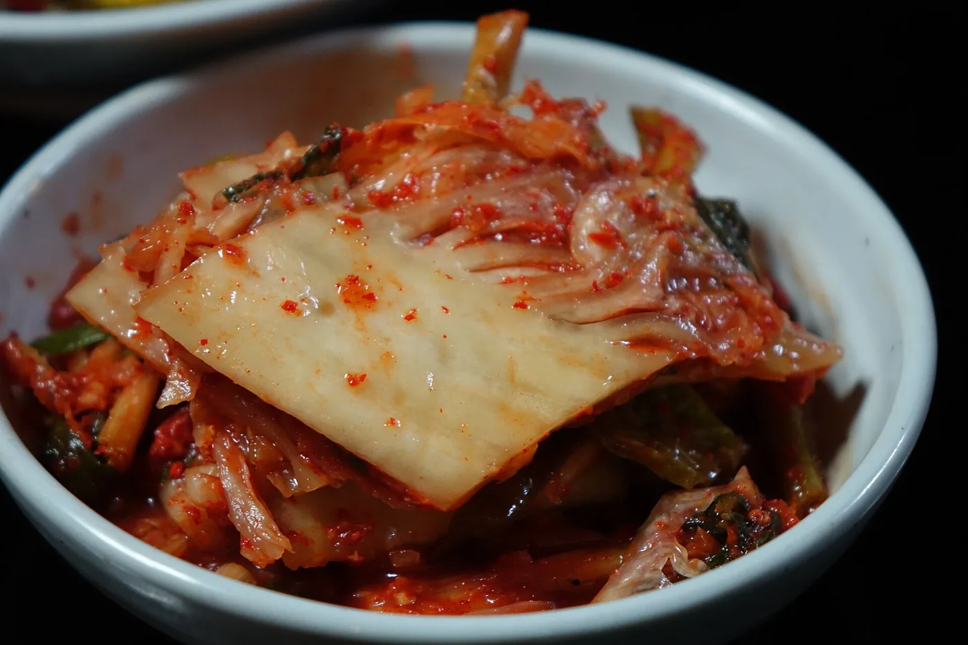 Napa cabbage kimchi on a white plate