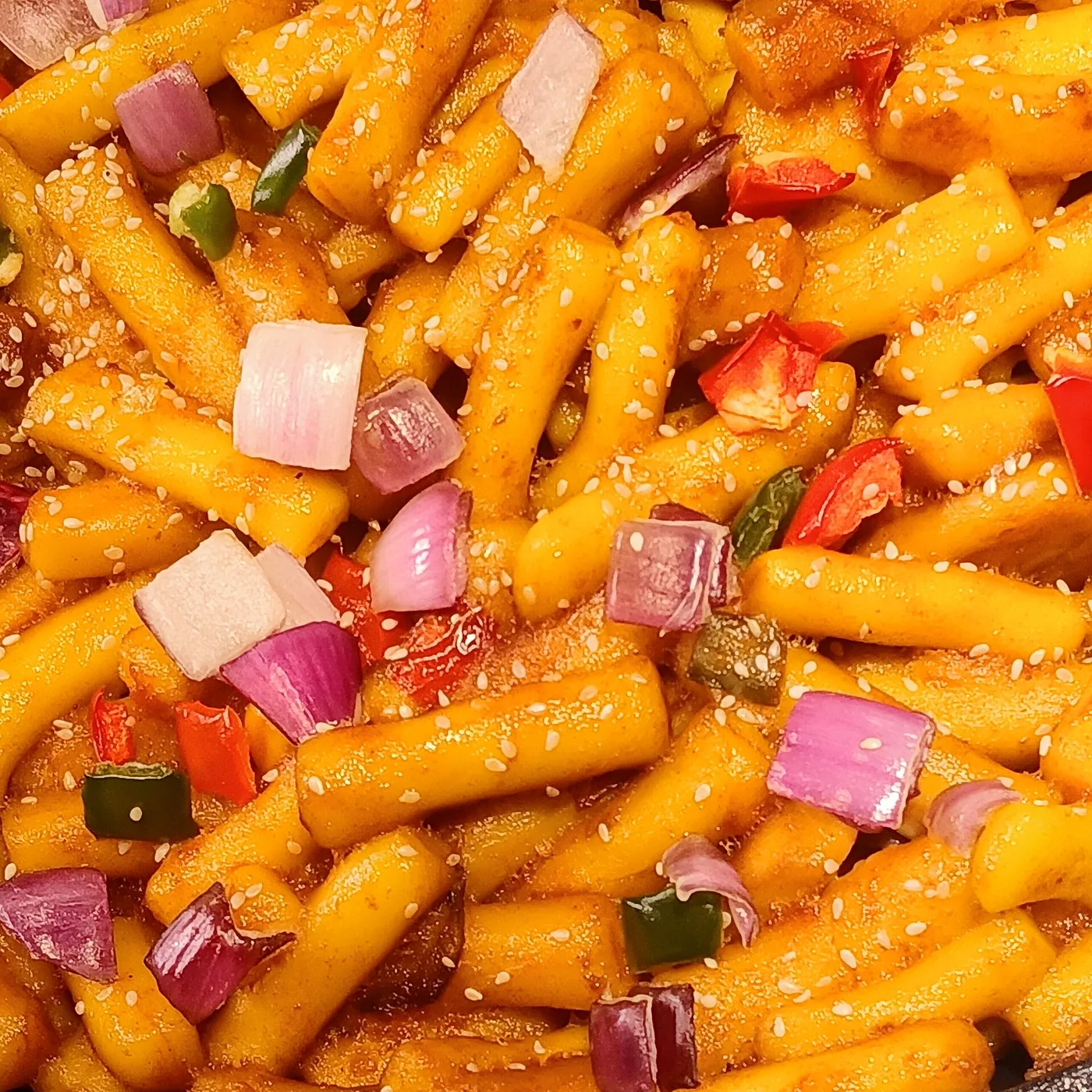 Tteokbokki rice cakes simmering in a red gochujang sauce